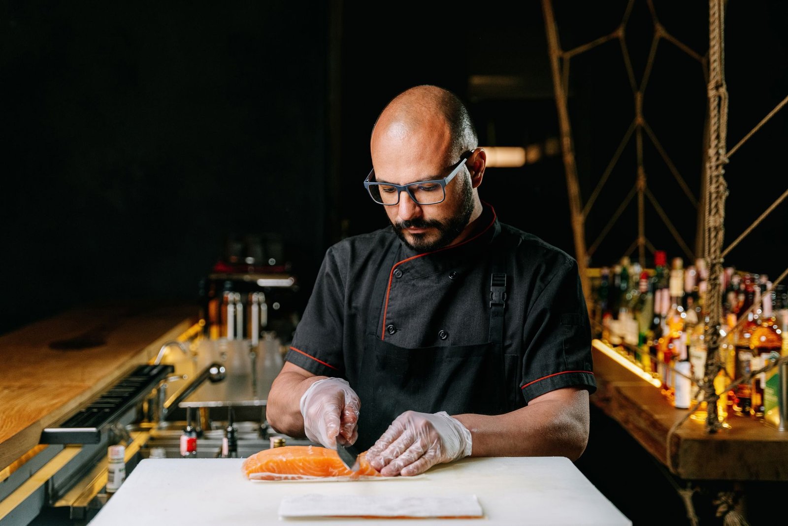 Chef preparing salmon in a professional kitchen