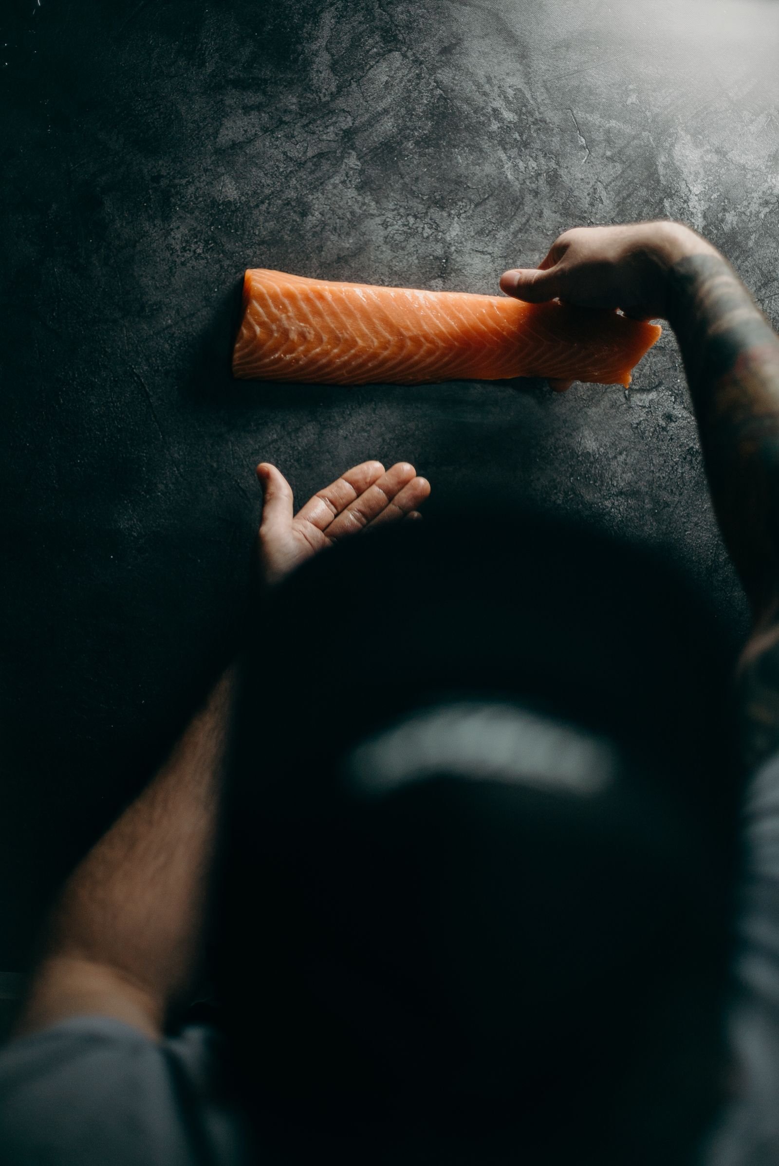 Salmon handled carefully in a professional preparation setting